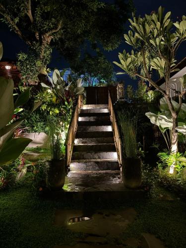a set of stairs in a garden at night at The Manja Retreat Lovina in Buleleng