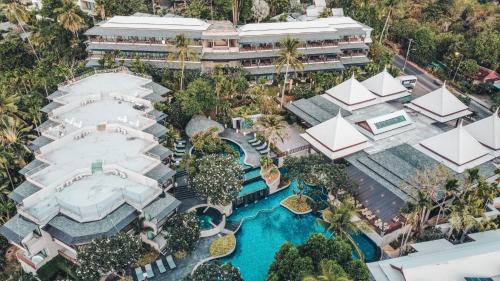 an aerial view of a resort with a pool at Andaman Cannacia Resort & Spa - SHA Extra Plus in Kata Beach