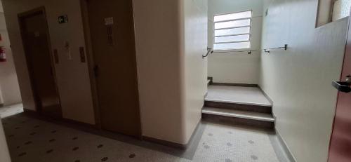 a hallway with a stair case and a window at Hotel Plaza Olido in Sao Paulo