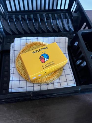 a yellow book sitting on a rack in a microwave at Villavos- Le Bocage in Cassis