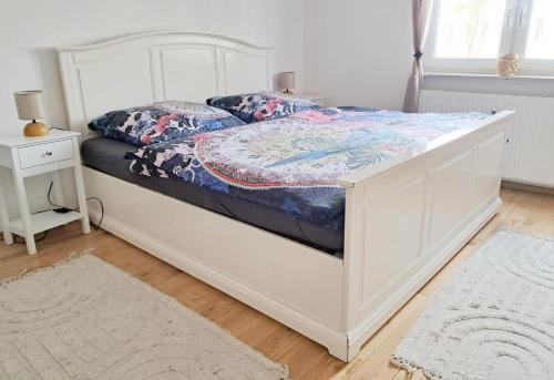a bedroom with a white bed with a white frame at Wohlfühloase in der City in Luckenwalde