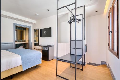 a bedroom with a bed and a glass case at Hotel Murillo Reinoso in Seville