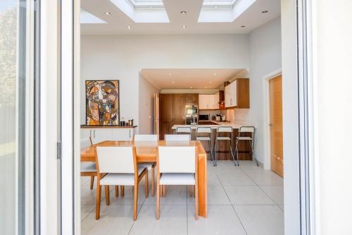 a dining room and kitchen with a table and chairs at Double room in Bromley in Bromley