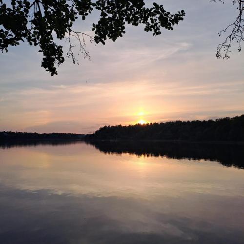 a view of a lake with the sun setting at Stunning6B2B views,jacuzzi,sauna in Sättra