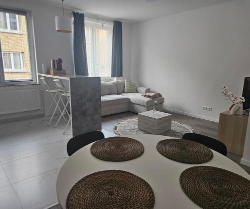 a white living room with a table and chairs at Brussels apartment with terrace 2 in Brussels