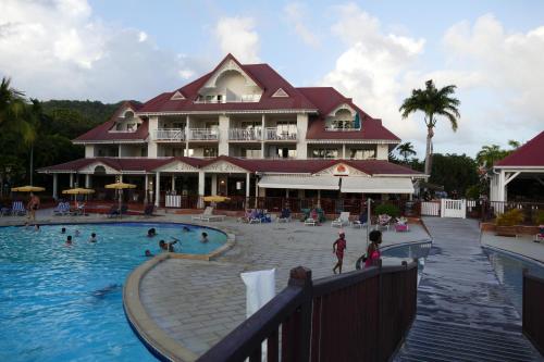 a large resort with a pool and people in it at Village vacances Sainte LUCE studio ANTIGUA 4 in Sainte-Luce