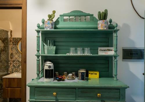 a green shelf with a coffee maker on it at La casa nel Borgo in San Donato Val di Comino
