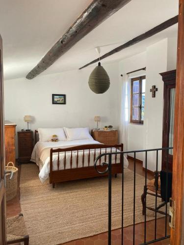 a bedroom with a large bed in a room at La maison Madeleine in Nyons