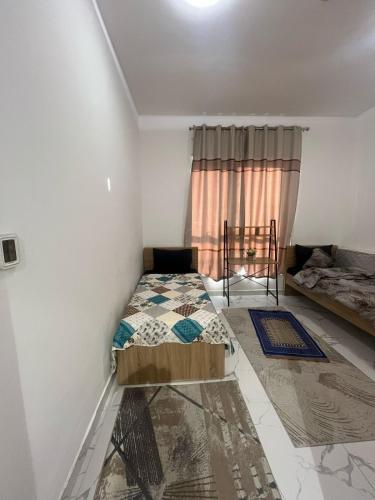 a bedroom with a bed and a window at oasis tower family apartment 2602 in Ajman