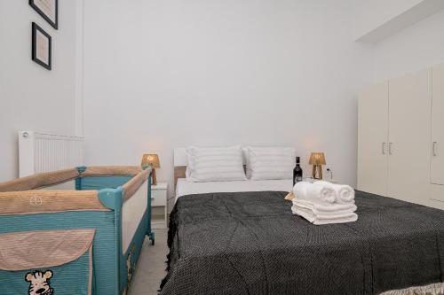 a bedroom with a bed with towels on it at HomeStory AXD in Alexandroupoli