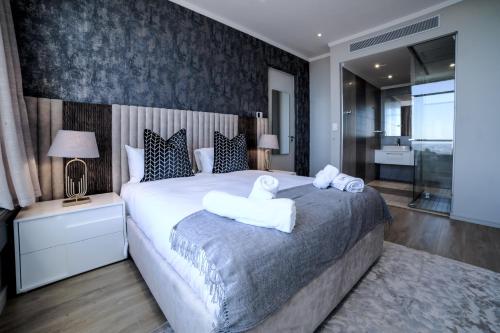 a bedroom with a large bed with towels on it at Masingita Towers Hotel and SPA in Johannesburg