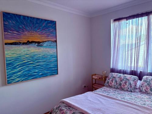 a bedroom with a bed and a painting on the wall at Toodyay Upon Avon Guest House and Gallery in Toodyay