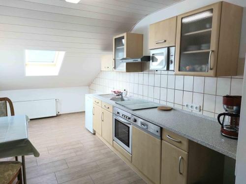 a kitchen with a sink and a stove at Cebullas Ferienwohnung in Herzberg am Harz