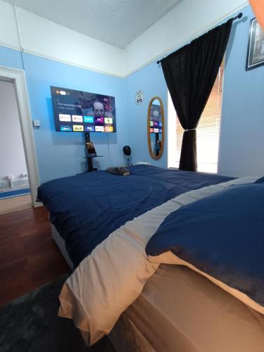 a bedroom with a large bed with a large screen at Castle Place in Newcastle