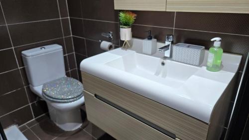 a bathroom with a white sink and a toilet at Sea front luxury living apartment in sousse in Sousse
