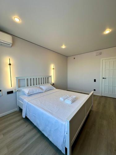 a bedroom with a large bed with white sheets at Апартаменты в 10 минутах от аэропорта Apartments 10 minutes from the airport in Astana