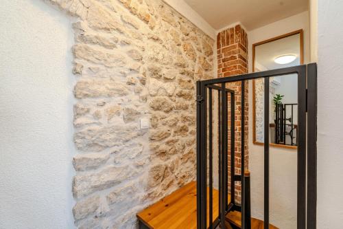 a stone wall in a hallway with a staircase at Roman style stone Villa Lux Solis in Nin