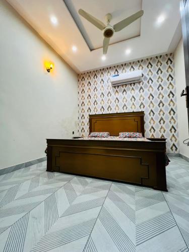 a bedroom with a bed and a ceiling fan at Dream Apartments in Ado Rāi