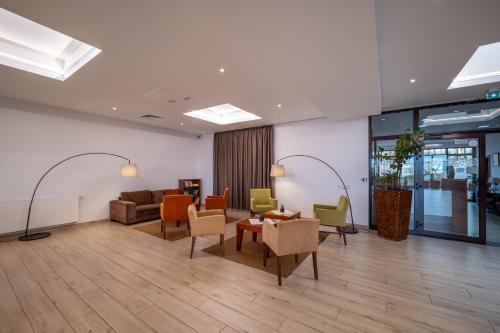 a lobby with a couch and chairs and a table at Hotel BELASSI in Bojnice