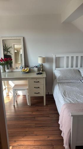 a bedroom with a desk with a bed and a mirror at Beautiful Property Close To London in Potters Bar