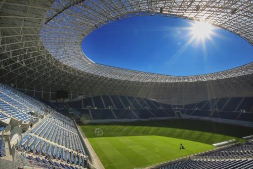 an empty stadium with a baseball game in it at The QUARK Modern Designed 2BR Central Apartment in Craiova