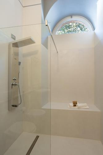 a bathroom with a shower with a glass door at Resort Antico Verbano in Meina