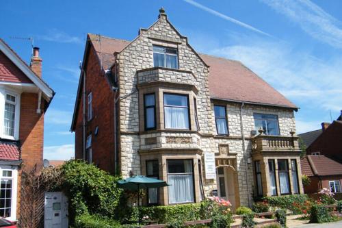 a large brick house with an umbrella in front of it at Modern 2 bedrooms apartment Skegness F3 in Skegness
