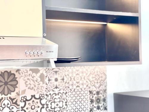 a close up of a stove top oven in a kitchen at SKY VILLA - BKK Phnom Penh - Rooms & Apartments - FREE LAUNDRY in Phnom Penh