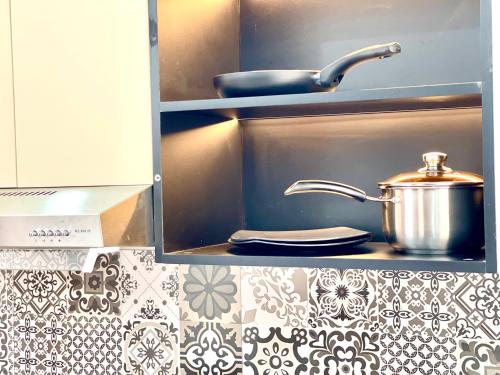 a cupboard with a pot on top of a kitchen counter at SKY VILLA - BKK Phnom Penh - Rooms & Apartments - FREE LAUNDRY in Phnom Penh
