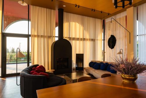 a living room with a table and a fireplace at Tsinandali Estate, A Radisson Collection Hotel in Tsinandali