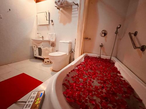 a bathroom with a tub filled with red hearts at The Classic Hill View Hotel, Near JW Marriott Mussoorie in Mussoorie