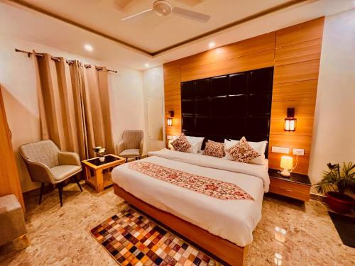 a bedroom with a large bed in a room at The Classic Hill View Hotel, Near JW Marriott Mussoorie in Mussoorie