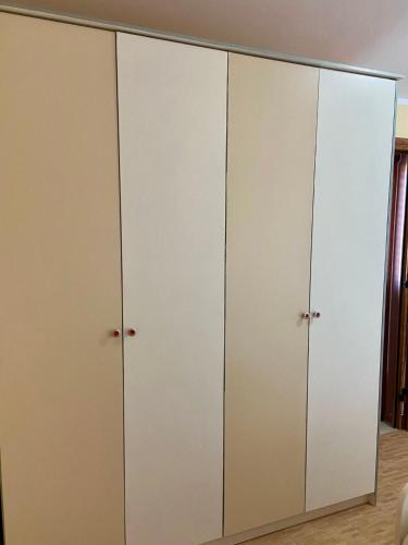 a pair of white wardrobes in a bedroom at VilaHasa in Tërbuf