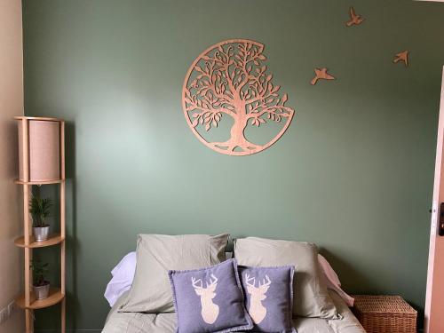 a bedroom with a tree sticker on the wall at IBI ENJOY Maison d'hôtes in Ligné