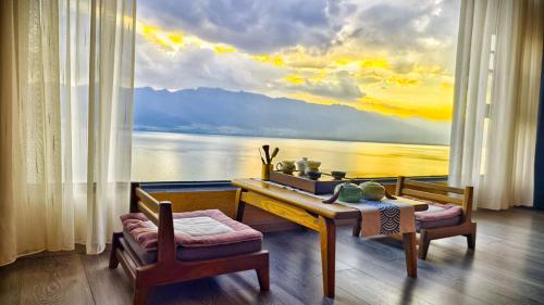 a room with a table and a view of the water at Super Invincible All Seaview Villa in Dali
