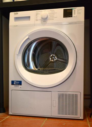 a washing machine is sitting on a floor at San Rocco in Giaveno