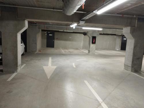 an empty parking garage with a car parked in it at EM apartman Tuzla in Tuzla