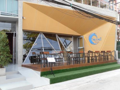 a restaurant with tables and chairs outside of a building at Sea Crest by Jomtien in Jomtien Beach
