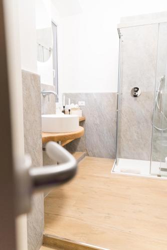 a bathroom with a shower and a sink at Alma Suites - Il Nido d'Amore in Livorno