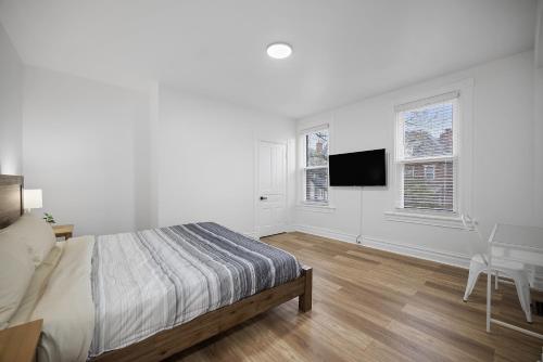 a white bedroom with a bed and a desk at Shadyside, Pittsburgh !F Modern and Bright Private Bedroom with Shared Bathroom in Pittsburgh