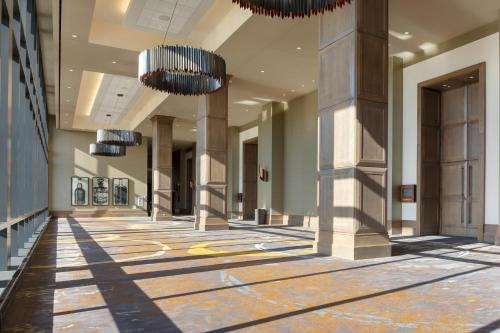 an empty hallway of a building with chandeliers at Omni Louisville Hotel in Louisville
