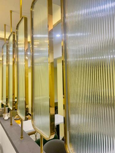 a row of mirrors in a room with tables and chairs at Thanh Premier Da Lat in Da Lat