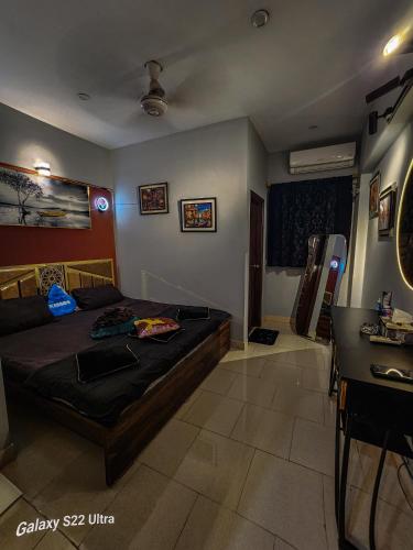 a bedroom with a bed and a table in it at Imperium luxe in Karachi