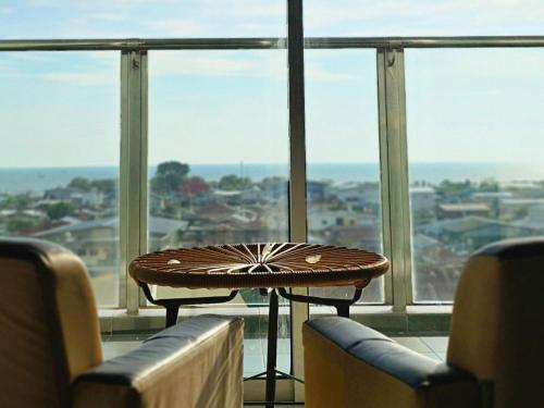 a table sitting in front of a large window at Enjoy the Unblocked Seaview 超大海景房 5mins to Paddy Fields and Pantai Redang in Sekincan