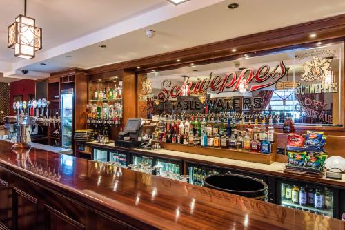a bar filled with lots of bottles of beer at Corr's Corner Hotel in Newtownabbey