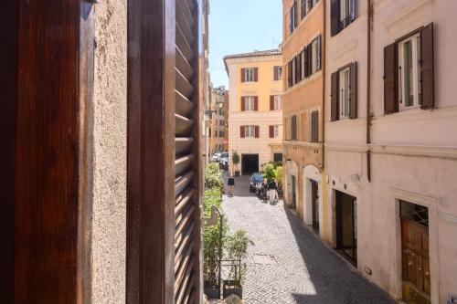 an alley in the city with people walking down the street at Puccini Flat in Rome