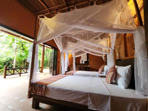 a bedroom with two large beds with white sheets at Whale Island Resort in Dam Mon