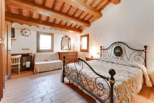 a bedroom with a bed and a desk in a room at Agriturismo CA DECIO in Cesena