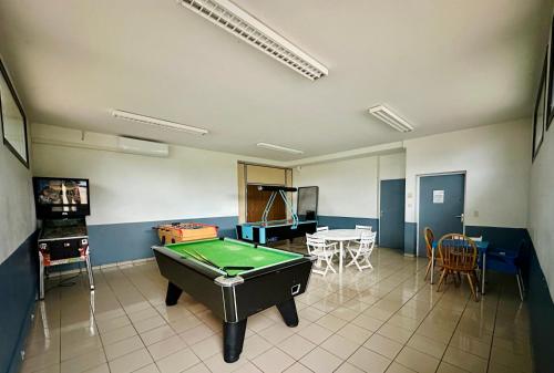 a room with a pool table and a ping pong ball at Camping Point Vert in Serrières-de-Briord
