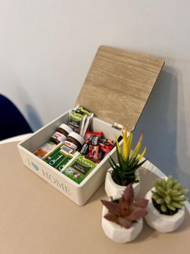 a box of food sitting on a table with plants at Sea View Apartment Montenegro in Bar, Susanj